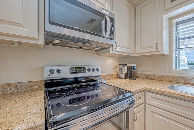 kitchen featuring white cabinets and appliances with stainless steel finishes