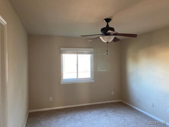 carpeted empty room with ceiling fan