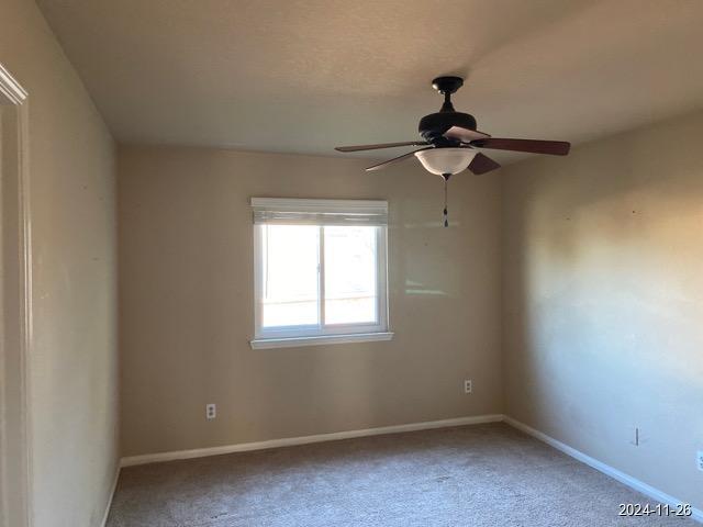 2102 Short Path Ct, Spring, TX 77373 - empty room featuring light carpet, a ceiling fan, and baseboards