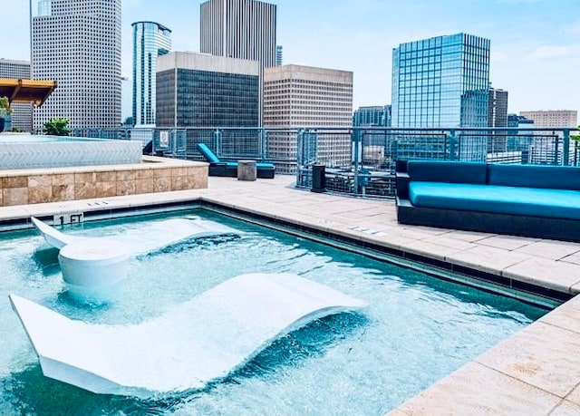 view of pool with a hot tub