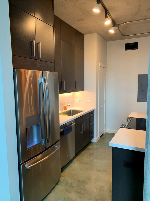 kitchen with rail lighting, sink, stainless steel appliances, and electric panel