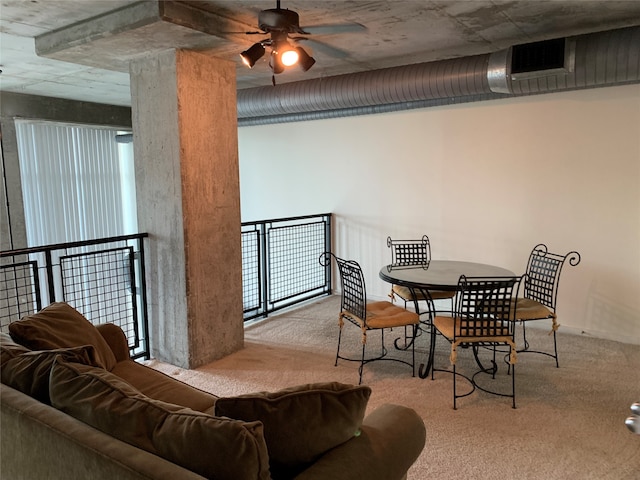 carpeted dining area featuring ceiling fan