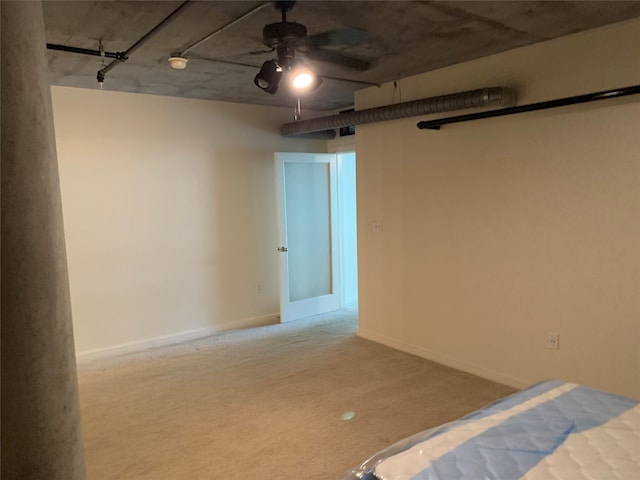 interior space featuring ceiling fan and light carpet