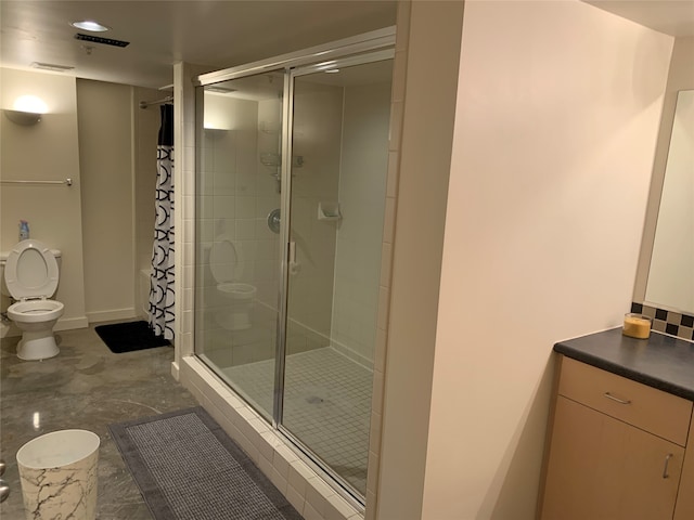 bathroom featuring vanity, toilet, and walk in shower