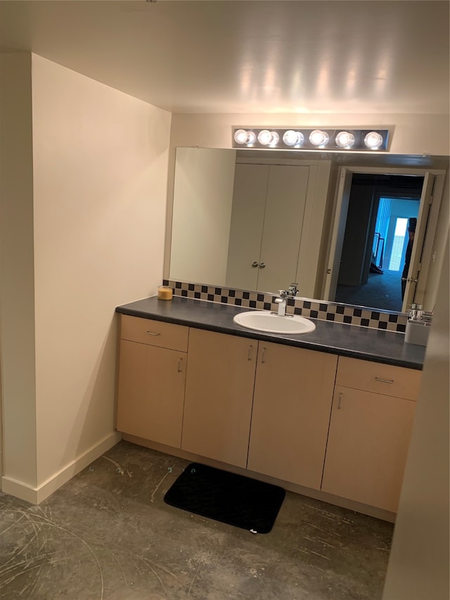 bathroom with vanity and tasteful backsplash