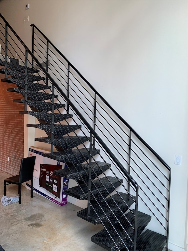 stairs featuring concrete floors