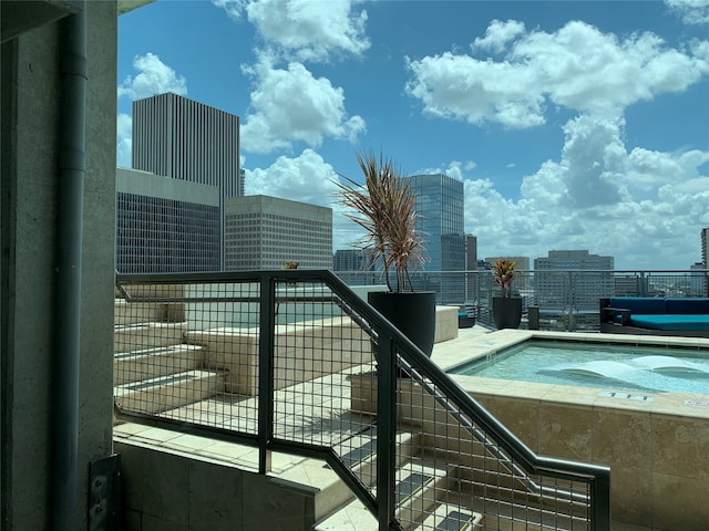 view of pool with a hot tub