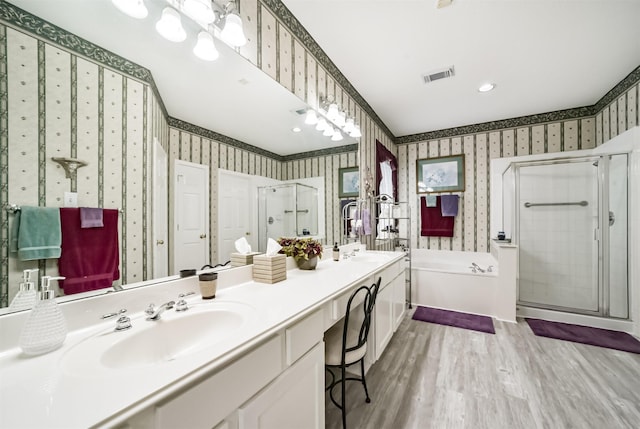 bathroom featuring vanity, independent shower and bath, and hardwood / wood-style flooring