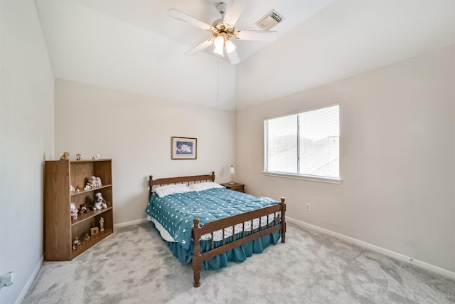 carpeted bedroom with ceiling fan and vaulted ceiling