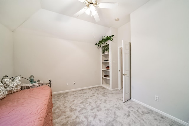 unfurnished bedroom with ceiling fan, light carpet, and vaulted ceiling