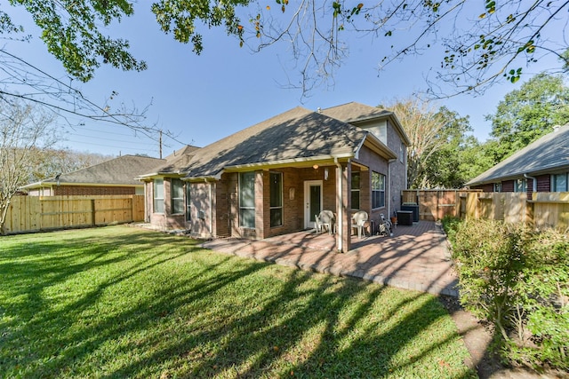 rear view of house featuring a patio, central AC unit, and a lawn