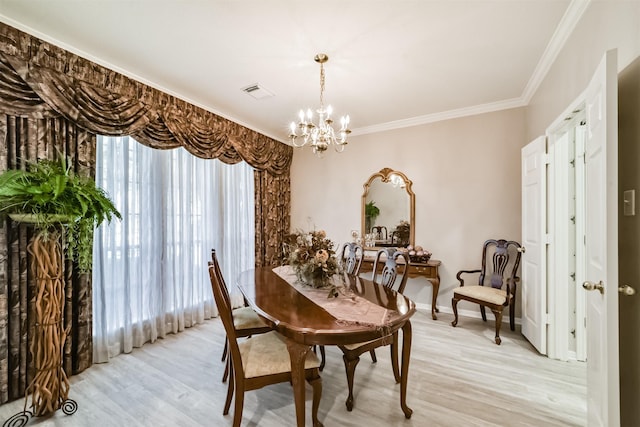 dining space with a chandelier, light hardwood / wood-style flooring, and crown molding