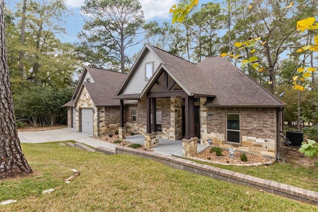 view of front of property with cooling unit, a garage, and a front lawn