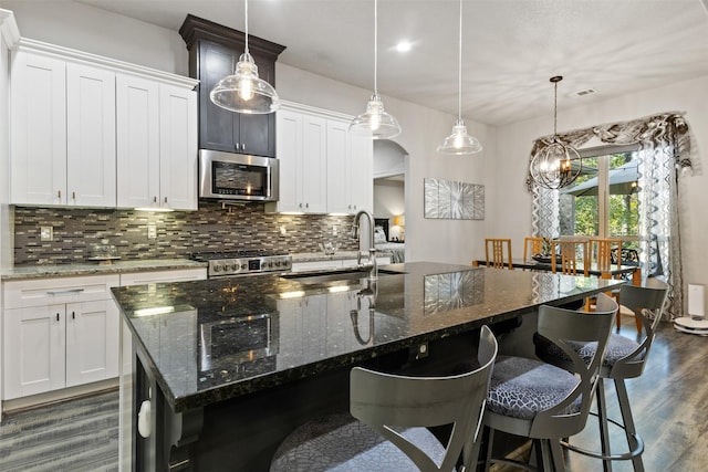 1617 Woodland Valley Dr, Huntsville, TX 77340 - kitchen featuring a center island with sink, white cabinets, and appliances with stainless steel finishes