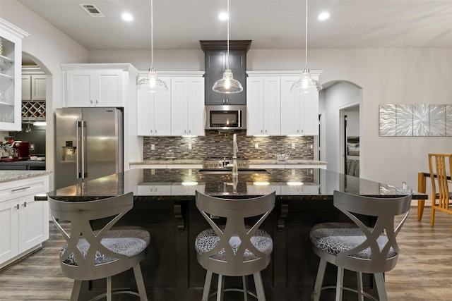 1617 Woodland Valley Dr, Huntsville, TX 77340 - kitchen with a breakfast bar, appliances with stainless steel finishes, and a kitchen island with sink
