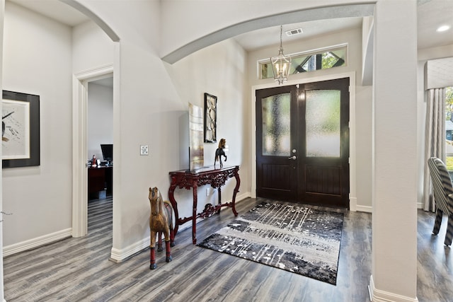 entryway with french doors, an inviting chandelier, and hardwood / wood-style flooring