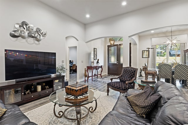 living room featuring a chandelier and light wood-type flooring