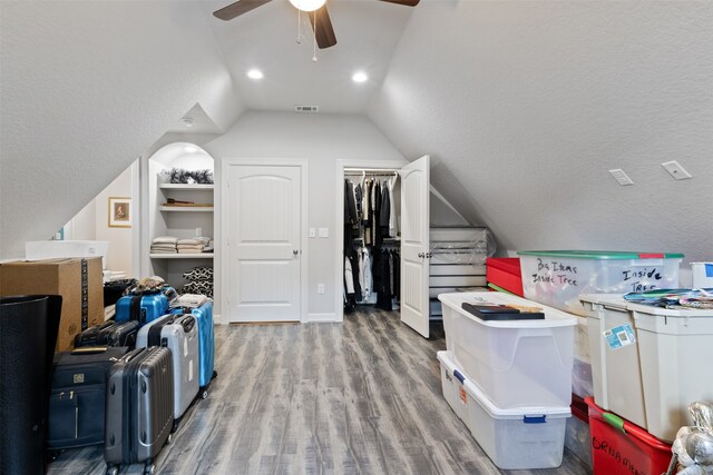 bonus room with a textured ceiling, light wood-type flooring, ceiling fan, and lofted ceiling