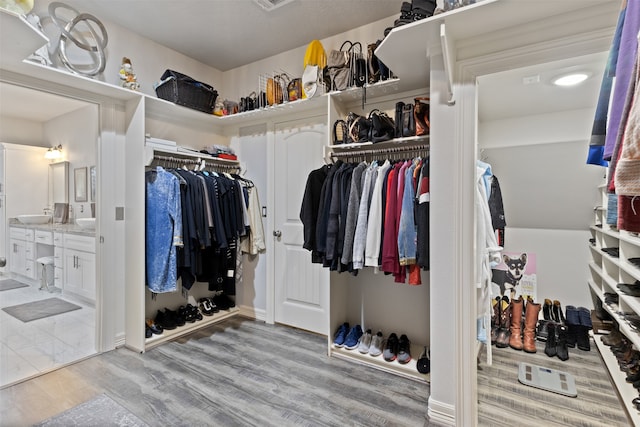 spacious closet featuring light hardwood / wood-style flooring