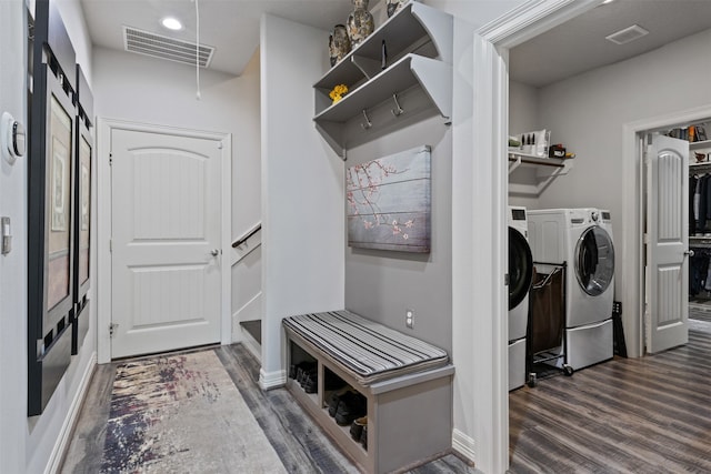 laundry room featuring washer and clothes dryer and dark wood-type flooring