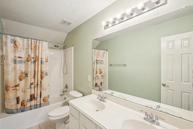 full bathroom with tile patterned floors, shower / bath combination with curtain, a textured ceiling, toilet, and vanity