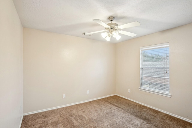 carpeted spare room with ceiling fan and a textured ceiling