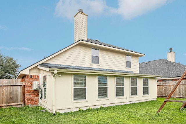 rear view of property with a lawn and ac unit