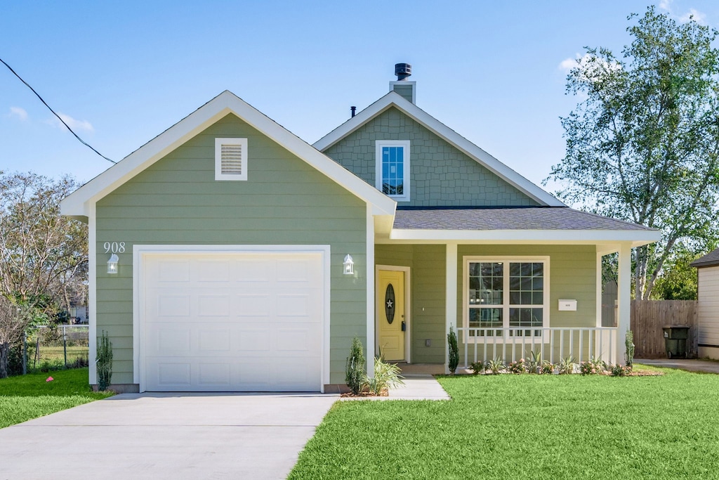 view of front facade with a porch, a garage, and a front lawn