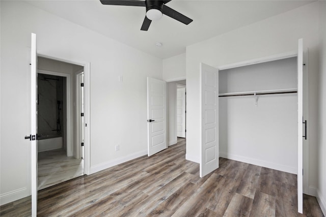 unfurnished bedroom with a closet, hardwood / wood-style flooring, and ceiling fan