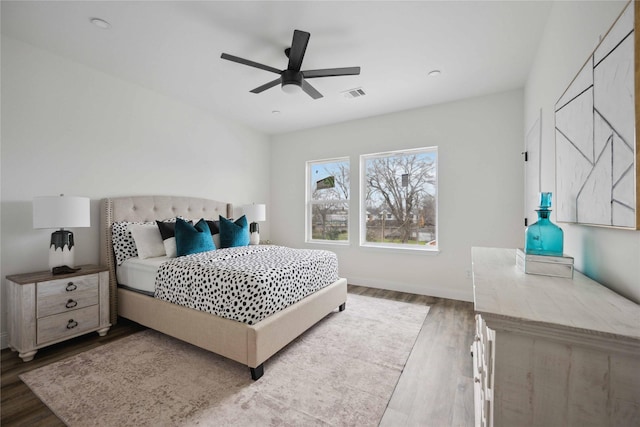 bedroom with hardwood / wood-style flooring and ceiling fan