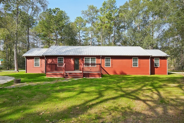 view of front of house featuring a front lawn and a wooden deck