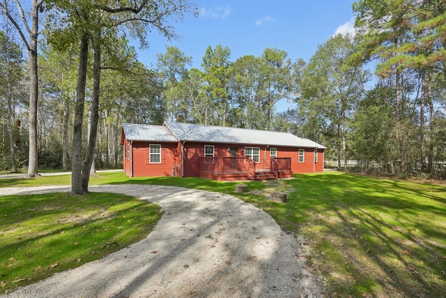 single story home with a front lawn and a wooden deck