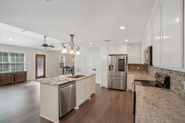 kitchen with sink, stainless steel appliances, dark hardwood / wood-style flooring, an island with sink, and decorative light fixtures