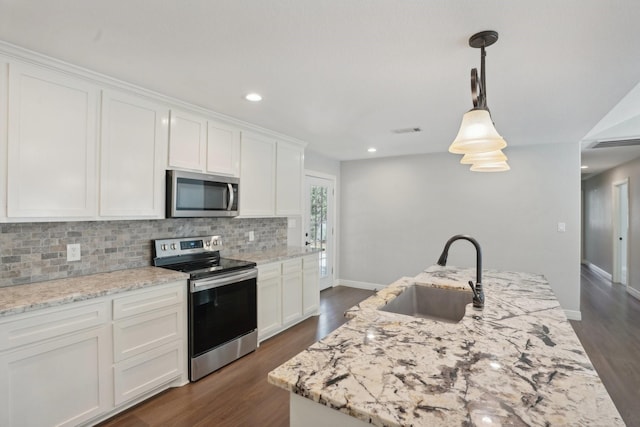 kitchen featuring pendant lighting, sink, white cabinets, and stainless steel appliances