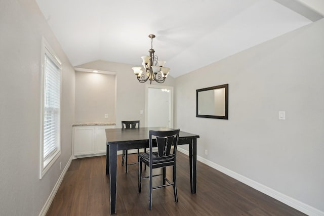 dining area with a notable chandelier, dark hardwood / wood-style floors, and vaulted ceiling