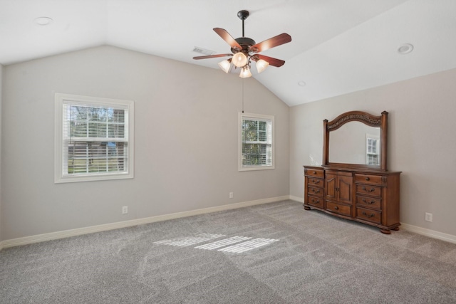 unfurnished bedroom with ceiling fan, light colored carpet, and vaulted ceiling