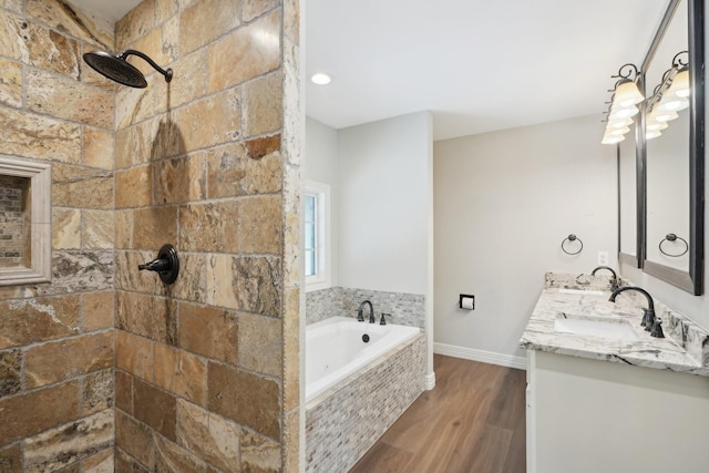 bathroom featuring independent shower and bath, vanity, and wood-type flooring