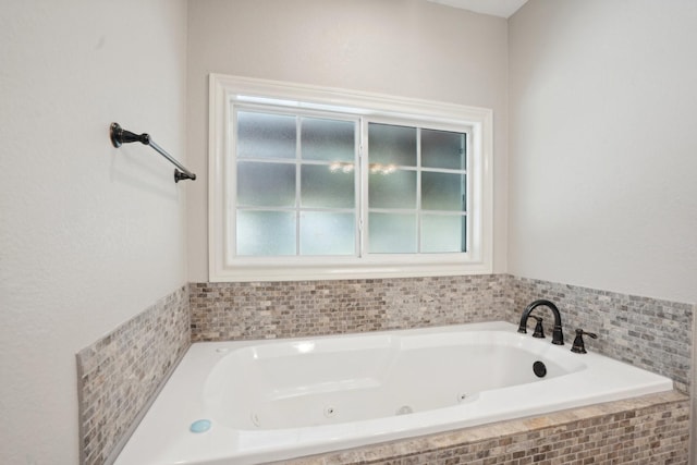 bathroom featuring tiled bath