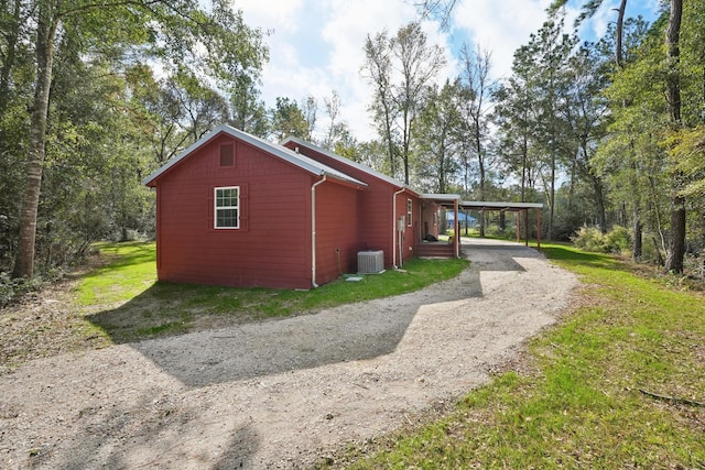 view of home's exterior featuring a carport and cooling unit