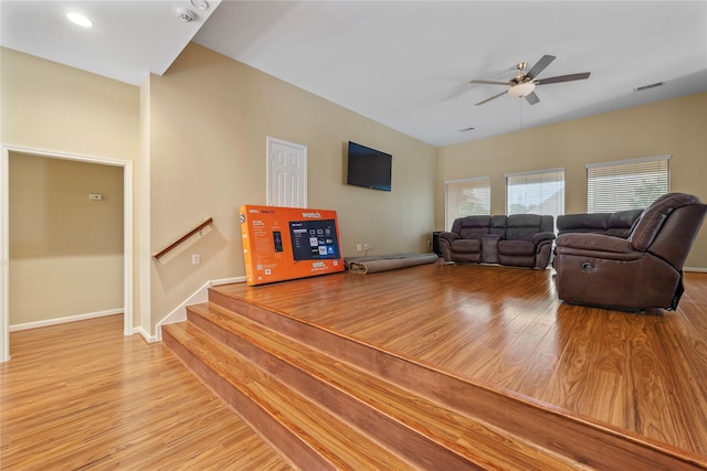 living room with light hardwood / wood-style floors and ceiling fan