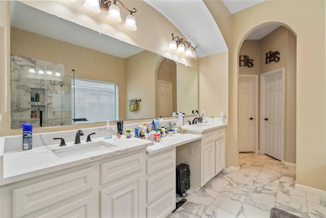 bathroom with a shower with door and vanity