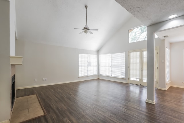 unfurnished living room featuring a textured ceiling, dark hardwood / wood-style flooring, high vaulted ceiling, and ceiling fan