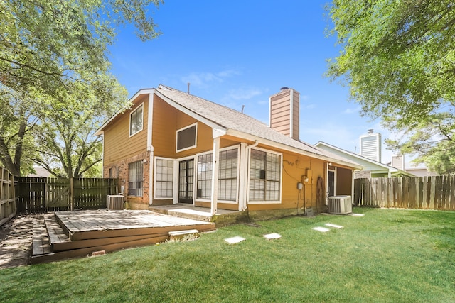 back of house with central AC unit, a yard, and a wooden deck