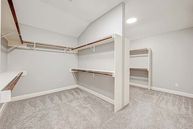 spacious closet with carpet flooring and vaulted ceiling