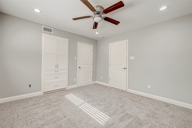 unfurnished bedroom with carpet floors and ceiling fan