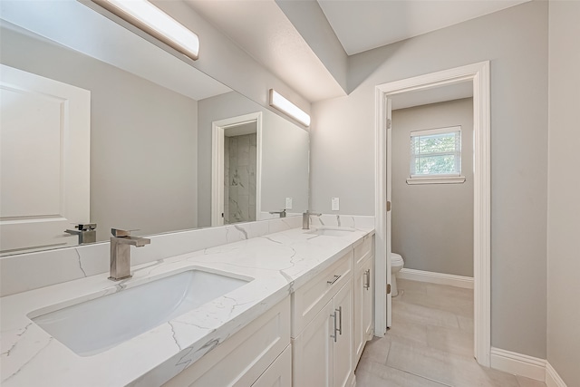 bathroom featuring tile patterned floors, vanity, and toilet