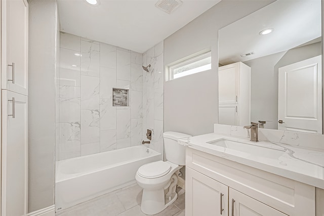 full bathroom featuring tile patterned flooring, vanity, toilet, and tiled shower / bath