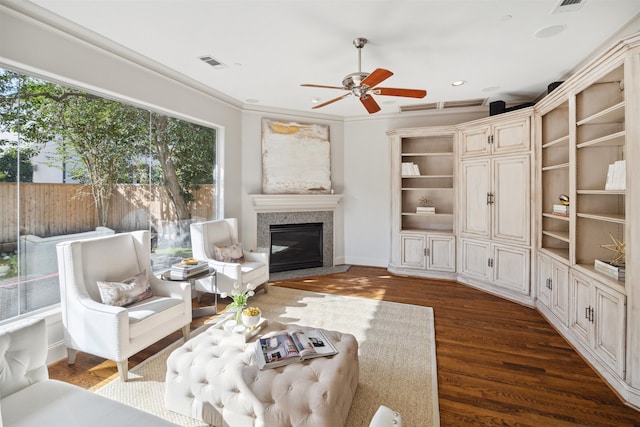 living room with ceiling fan, dark wood-type flooring, and ornamental molding