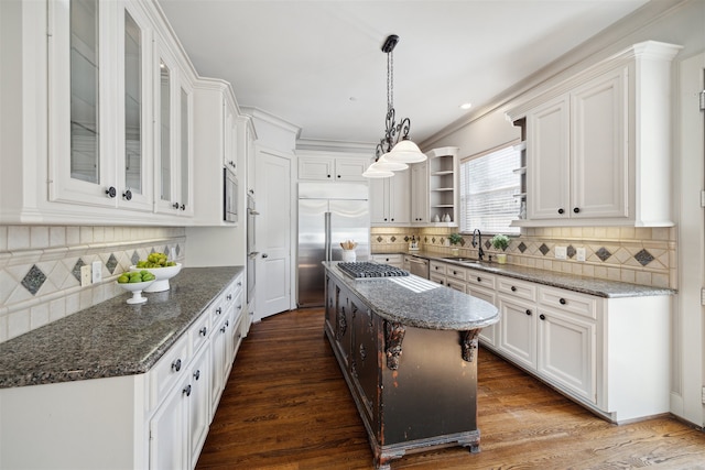 kitchen with a center island, dark hardwood / wood-style flooring, white cabinetry, and stainless steel appliances