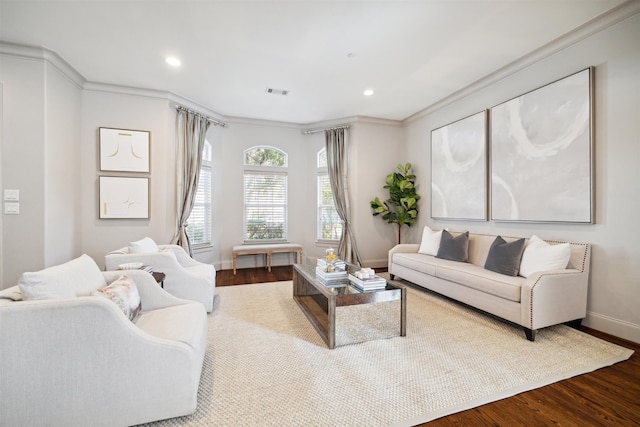 living room with hardwood / wood-style flooring and crown molding